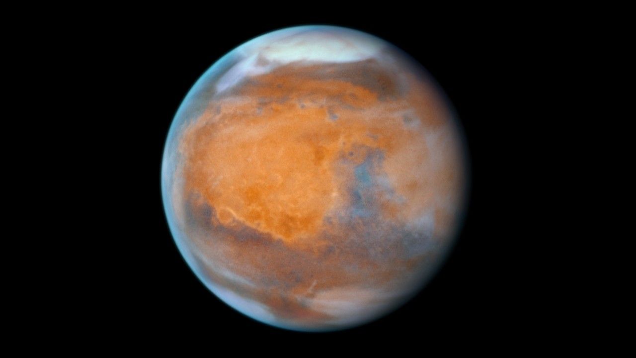 A view of planet Mars on a black background of space observed by the Hubble Space Telescope.