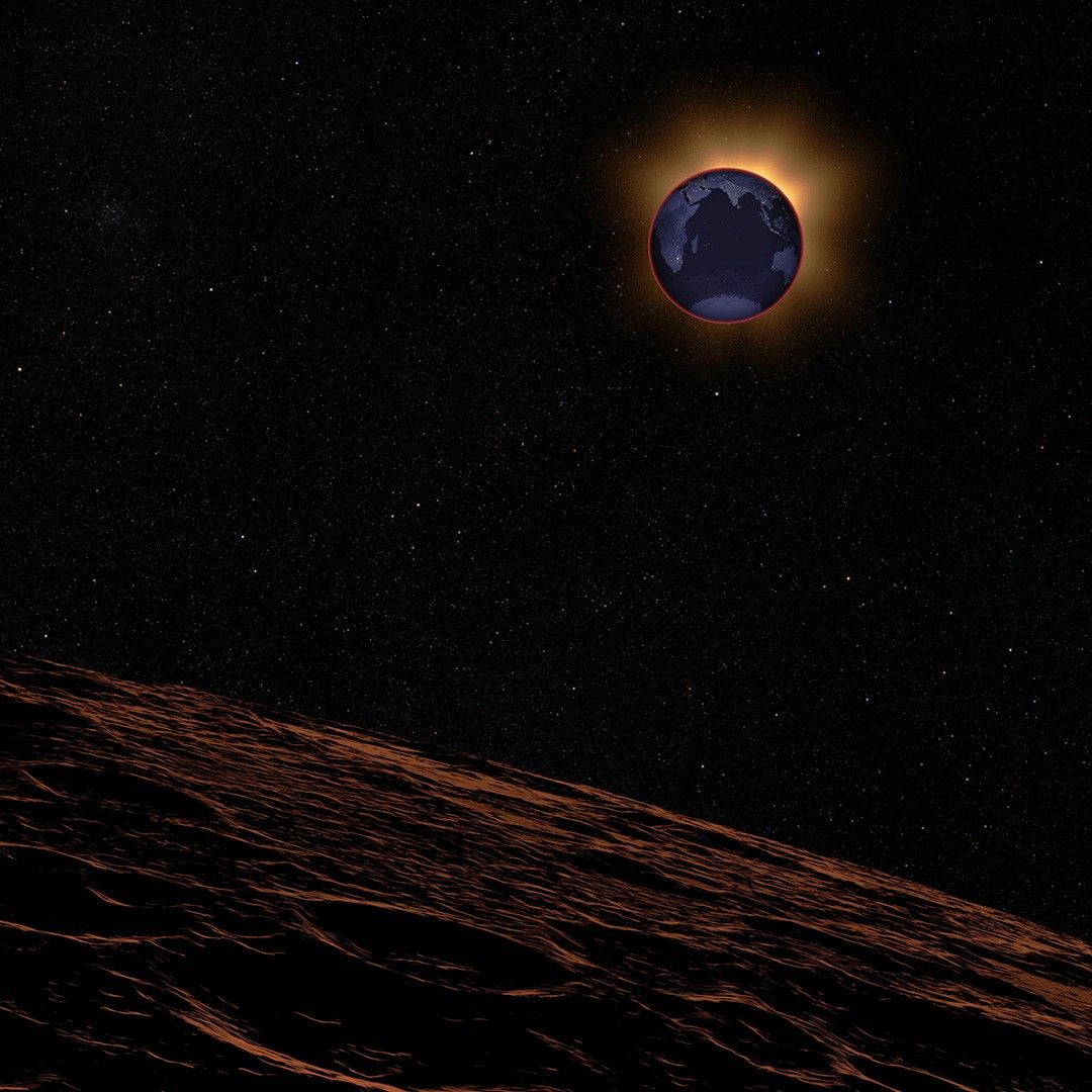 The landscape of the Moon, foreground, is reddened. In a black sky, Earth is backlit by the Sun.  